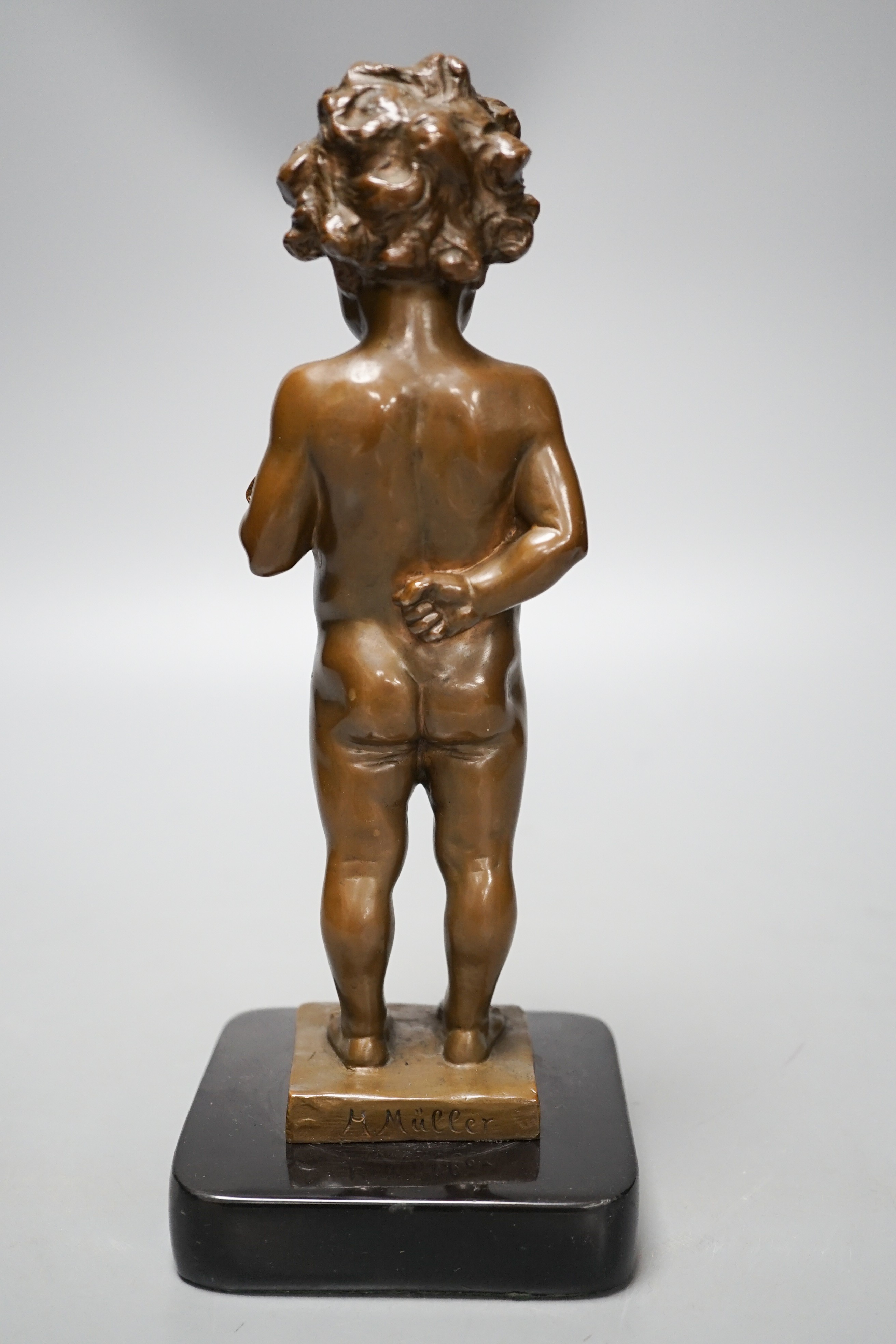 A bronze of a putto holding flowers, signed ‘M.Müller’ 25cm